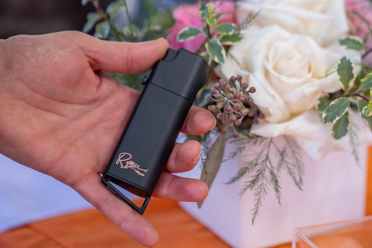 ROSE by SIG SAUER x Bestie self defense device in Matte Black with rose gold engraving, held in hand
