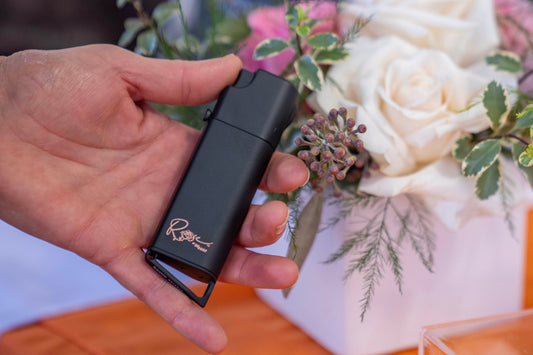 ROSE by SIG SAUER x Bestie self defense device in Matte Black with rose gold engraving, held in hand